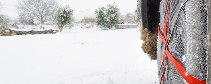 Wheel with ice chains for tires in a snowy field