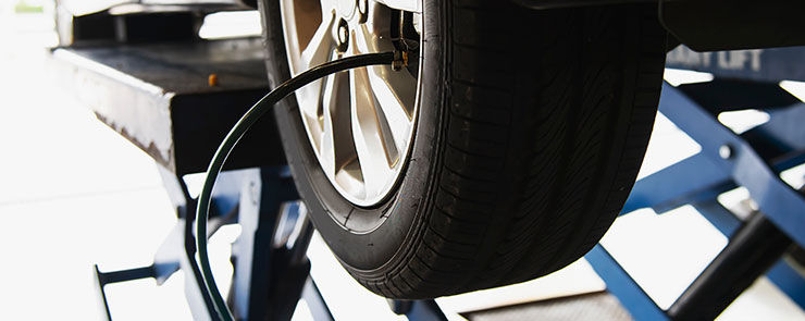 Technician is inflate car tire - car maintenance service transportation safety concept
